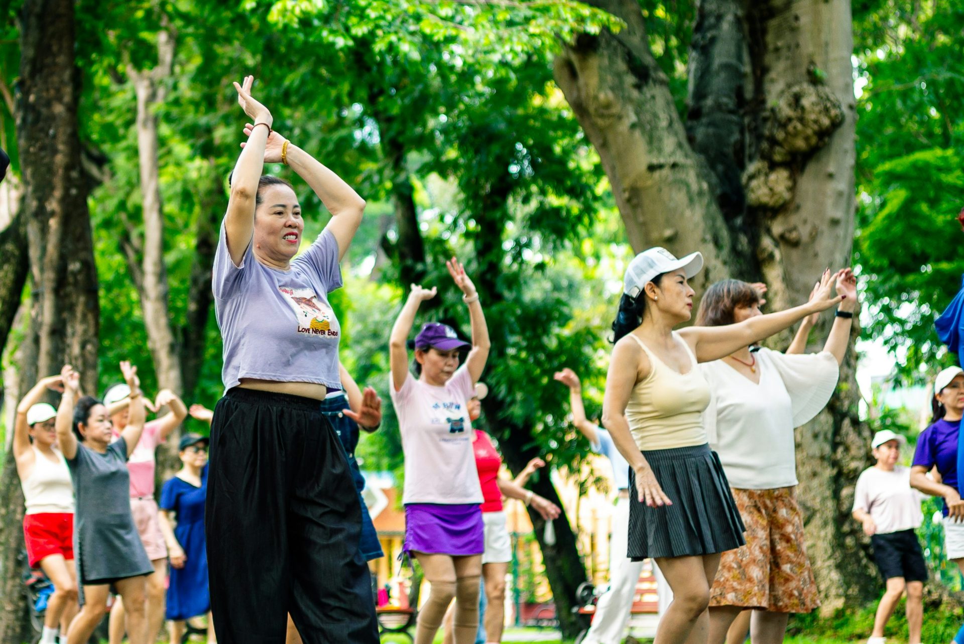 Group of people exercising outdoors in a park