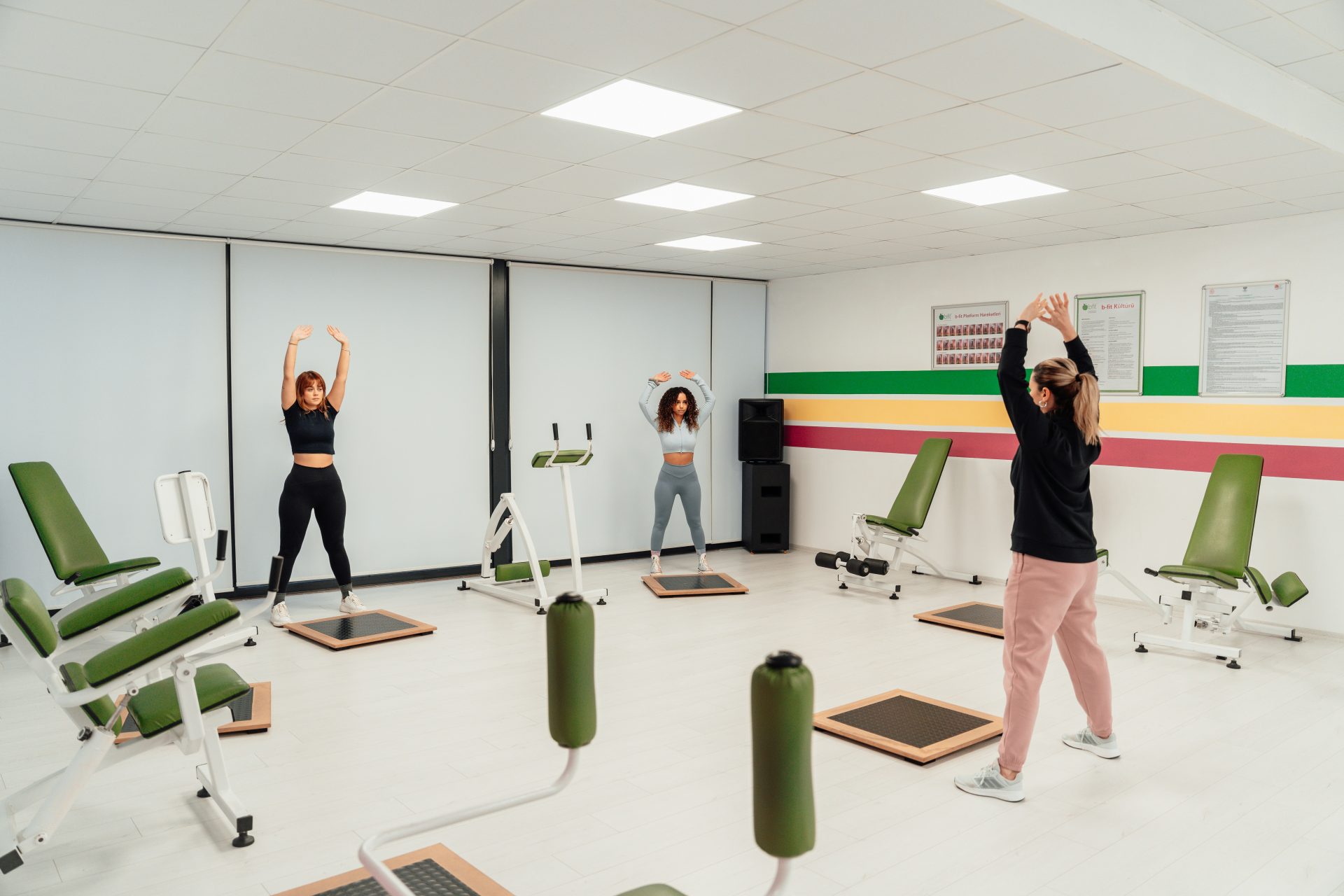 a group of people doing exercises in a gym