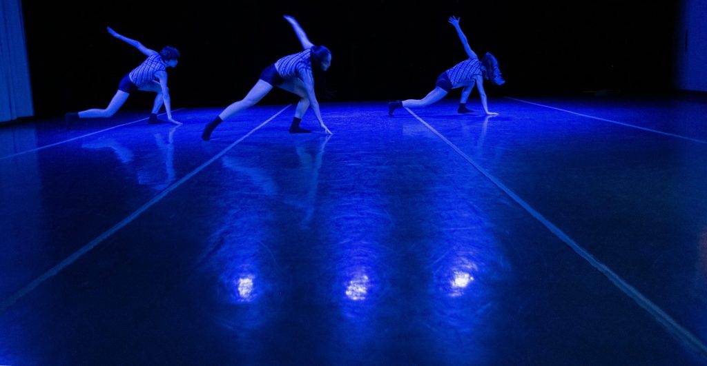 a group of dancers performing on a stage